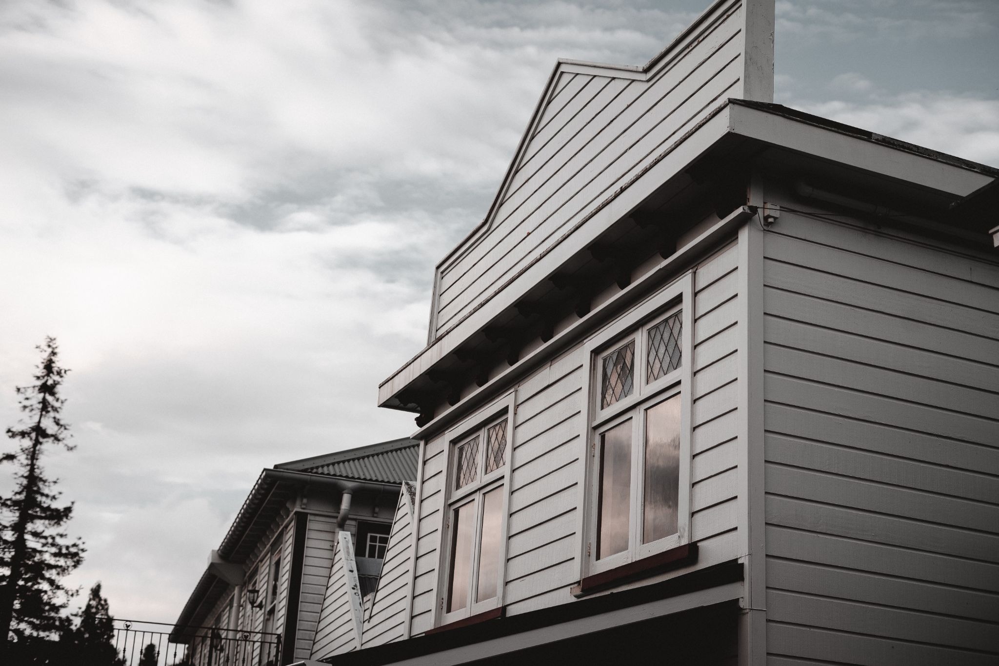 Close-up view of upper home exterior with gray vinyl siding panels