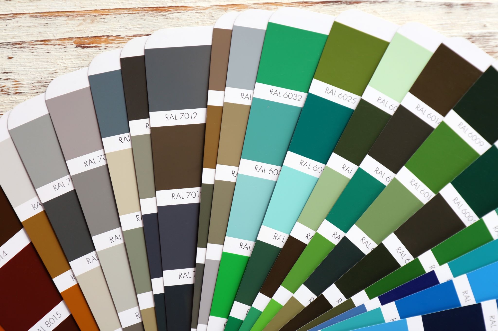Close-up of vinyl siding color palette samples showing a range of exterior shade options