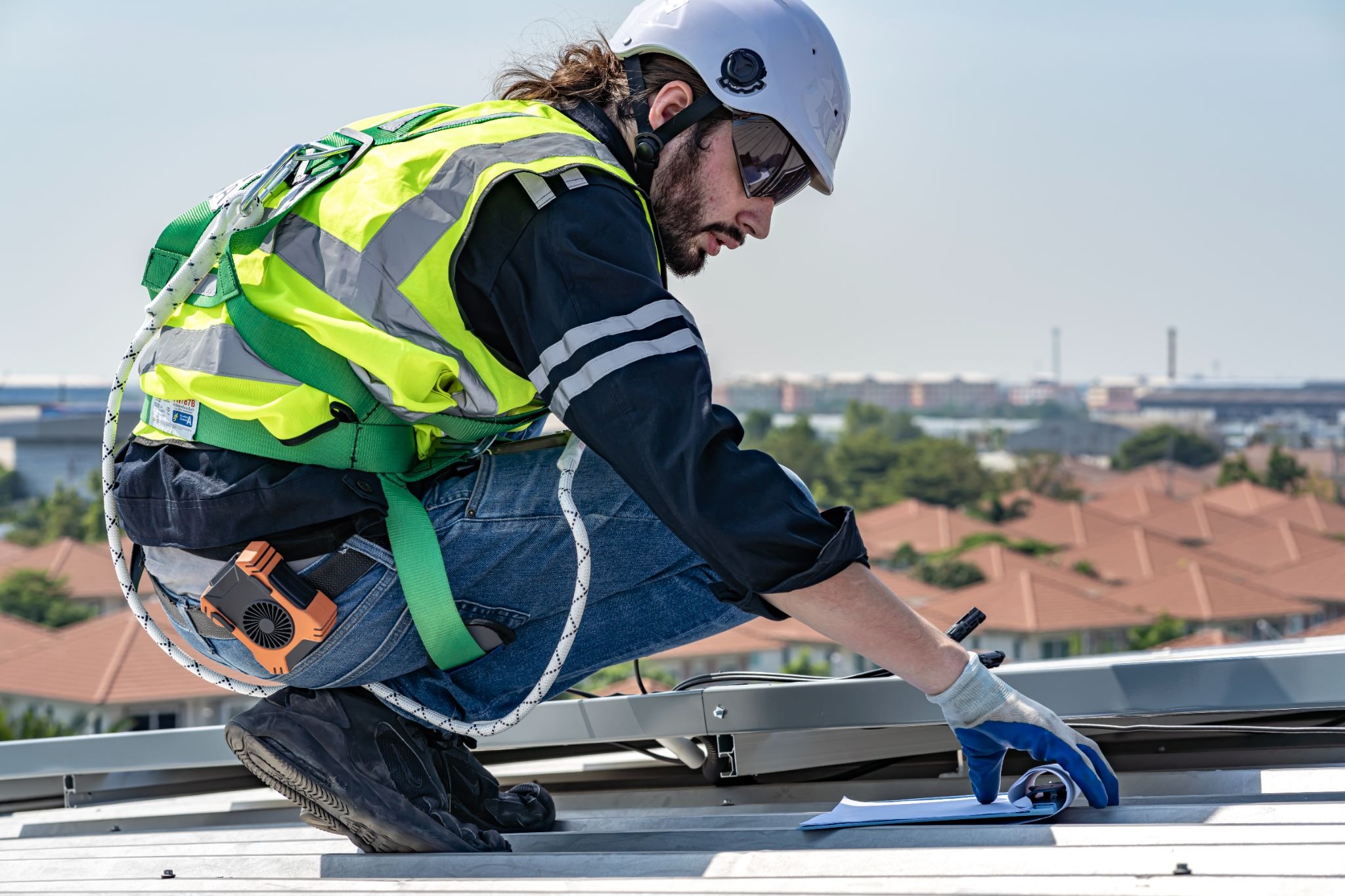Roof technician evaluating roof condition as part of preventive maintenance
